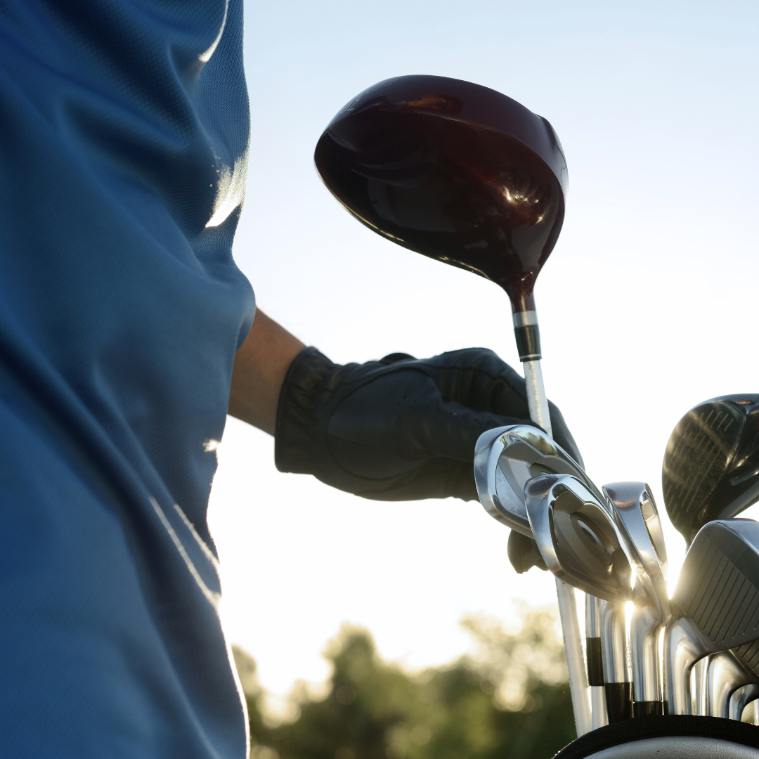 An oversized golf driver selected by a man